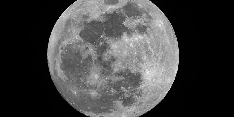 A full moon reflected over the ocean at night